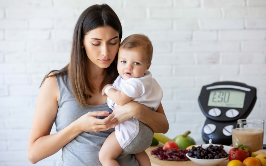 An Image Of A Mother Holding Her Baby In One Arm